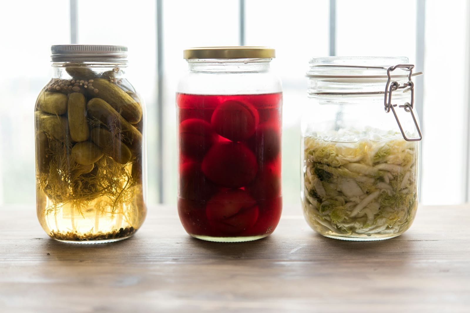 Three jars of fermented vegetables and fruit